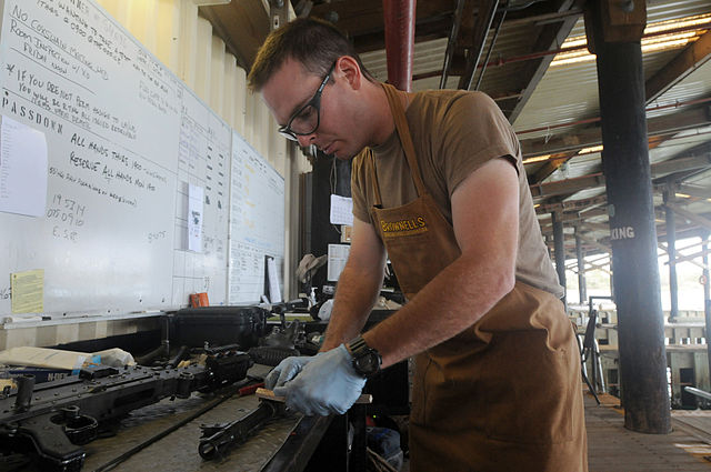 man cleaning a gun - gun maintenance perth